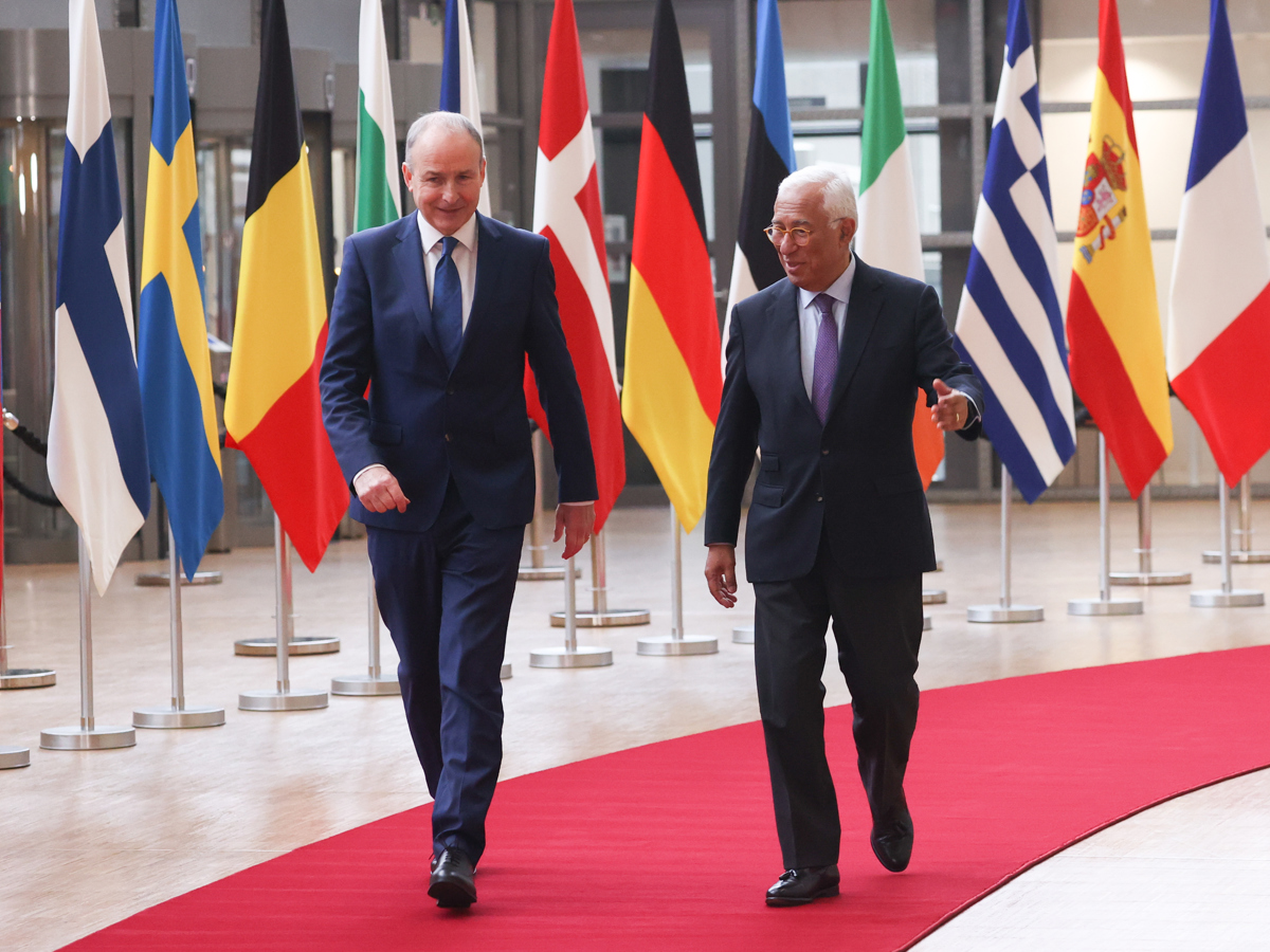 Two men walking on a red carpet