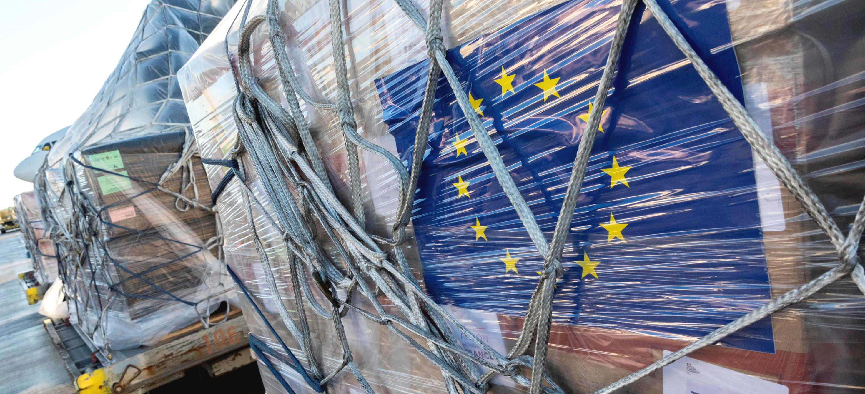 A shipment of aid and the flag of the European Union. 
