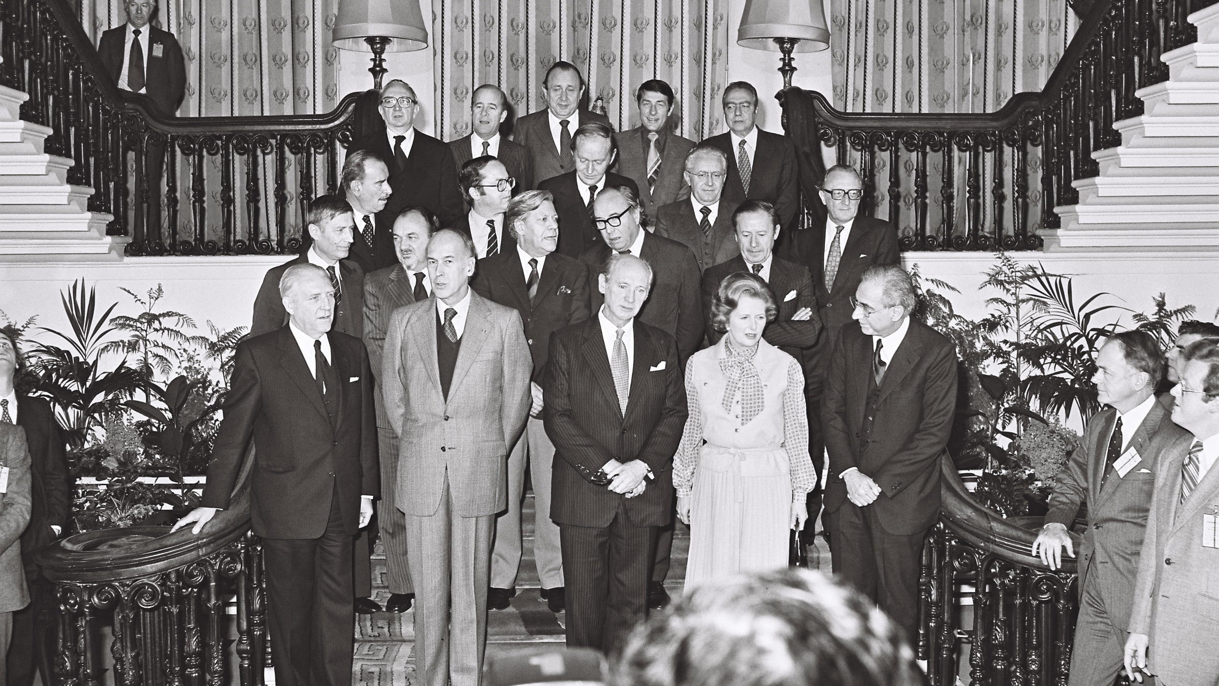 Irish and European political leaders posing for official photography on ornate staircase