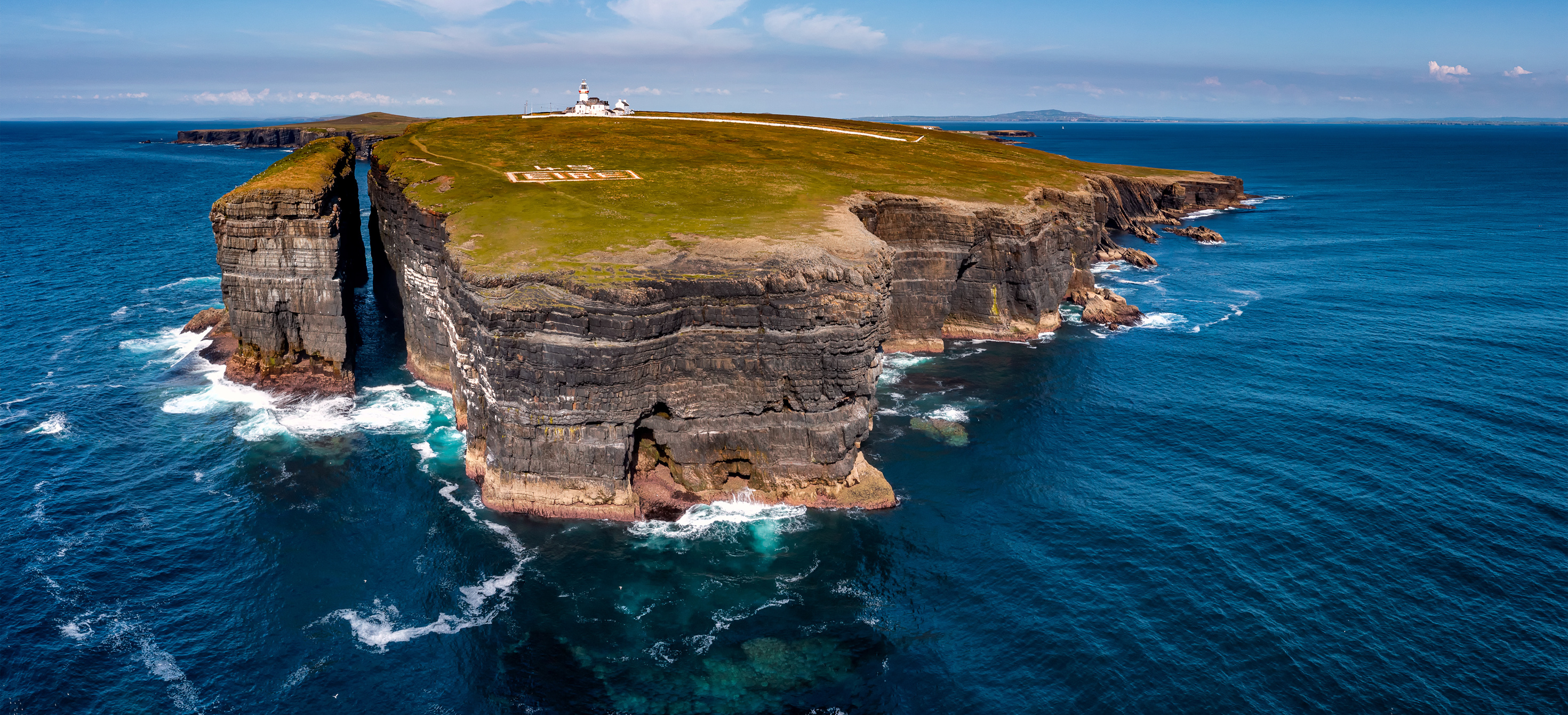 Irish coastline surrounded by deep blue water