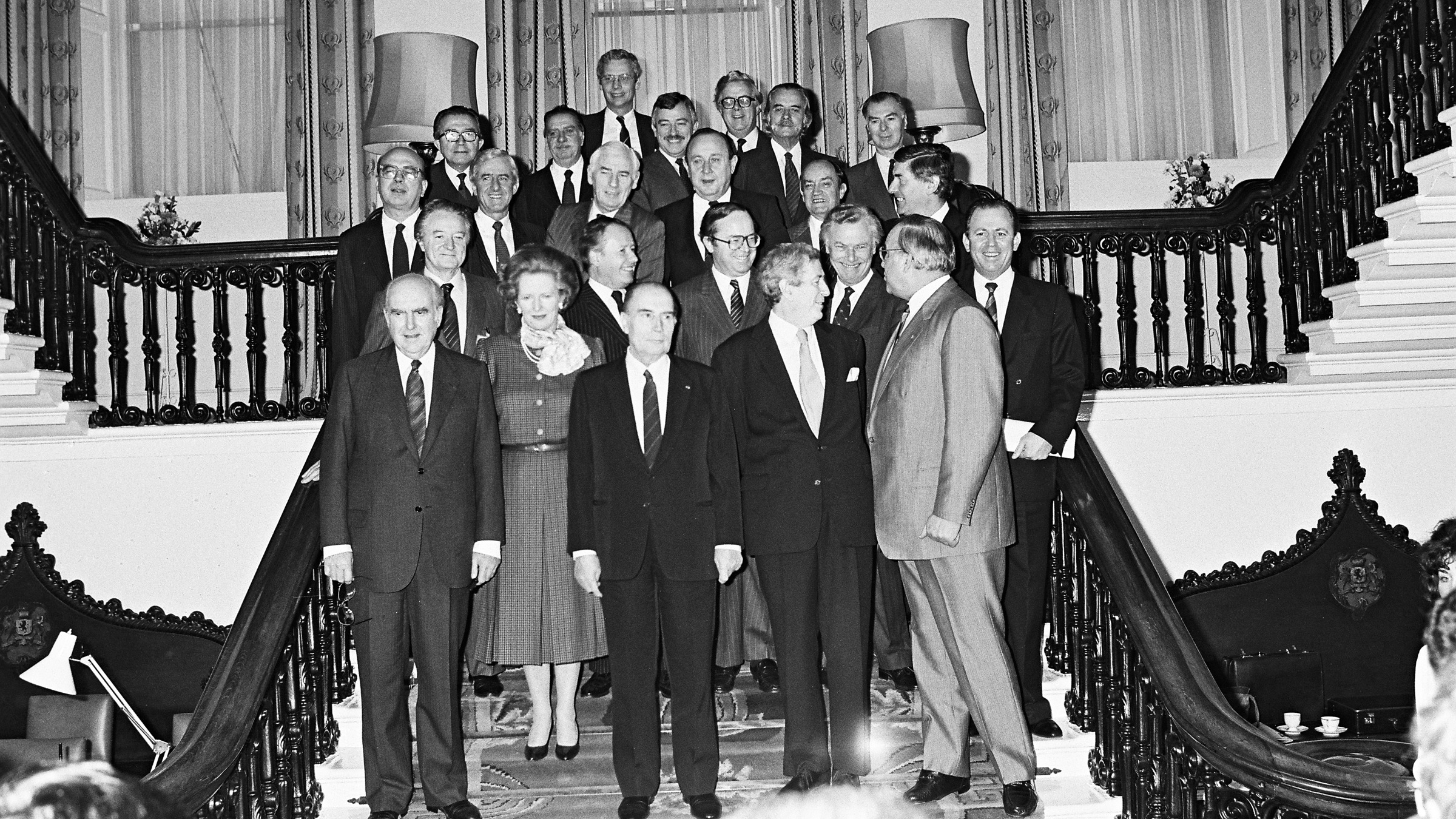 Irish and European political leaders posing for official photography on ornate staircase