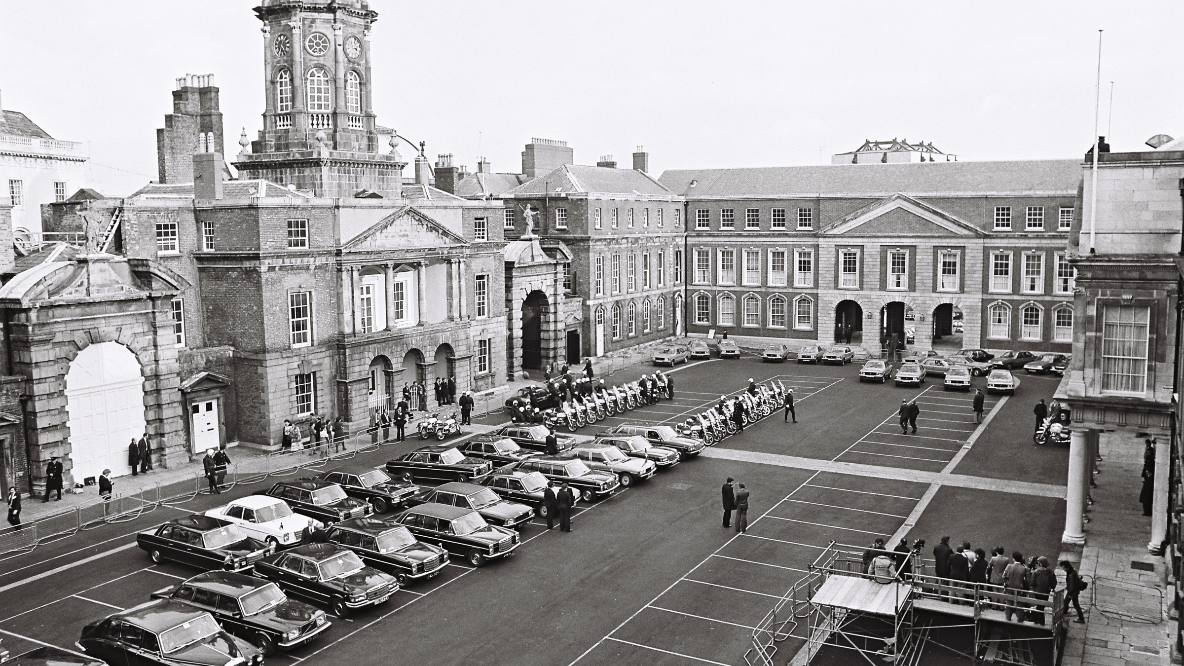 High-angle view of Dublin Castle courtyard with parked cars and people 