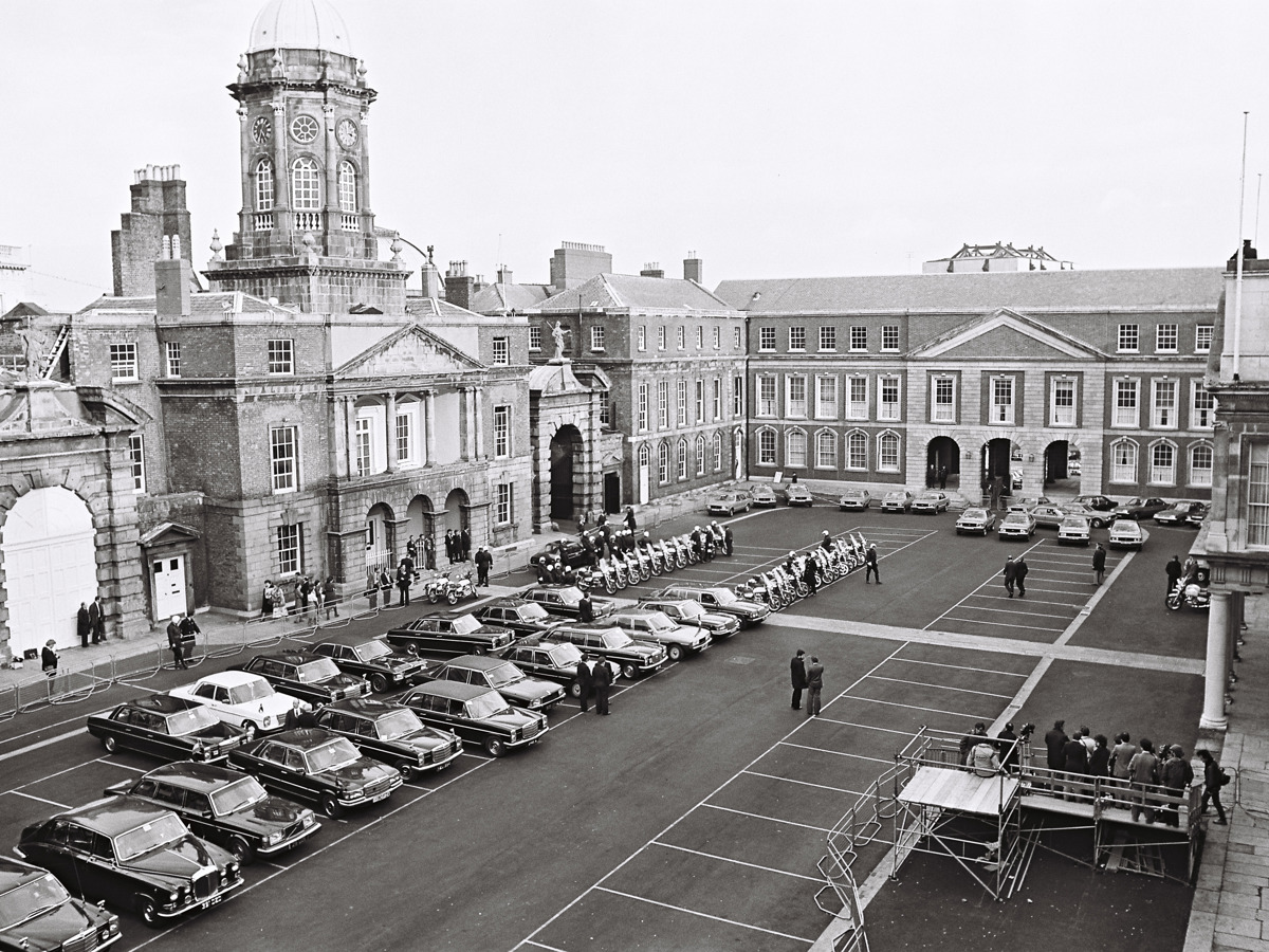 High-angle view of Dublin Castle courtyard with parked cars and people 