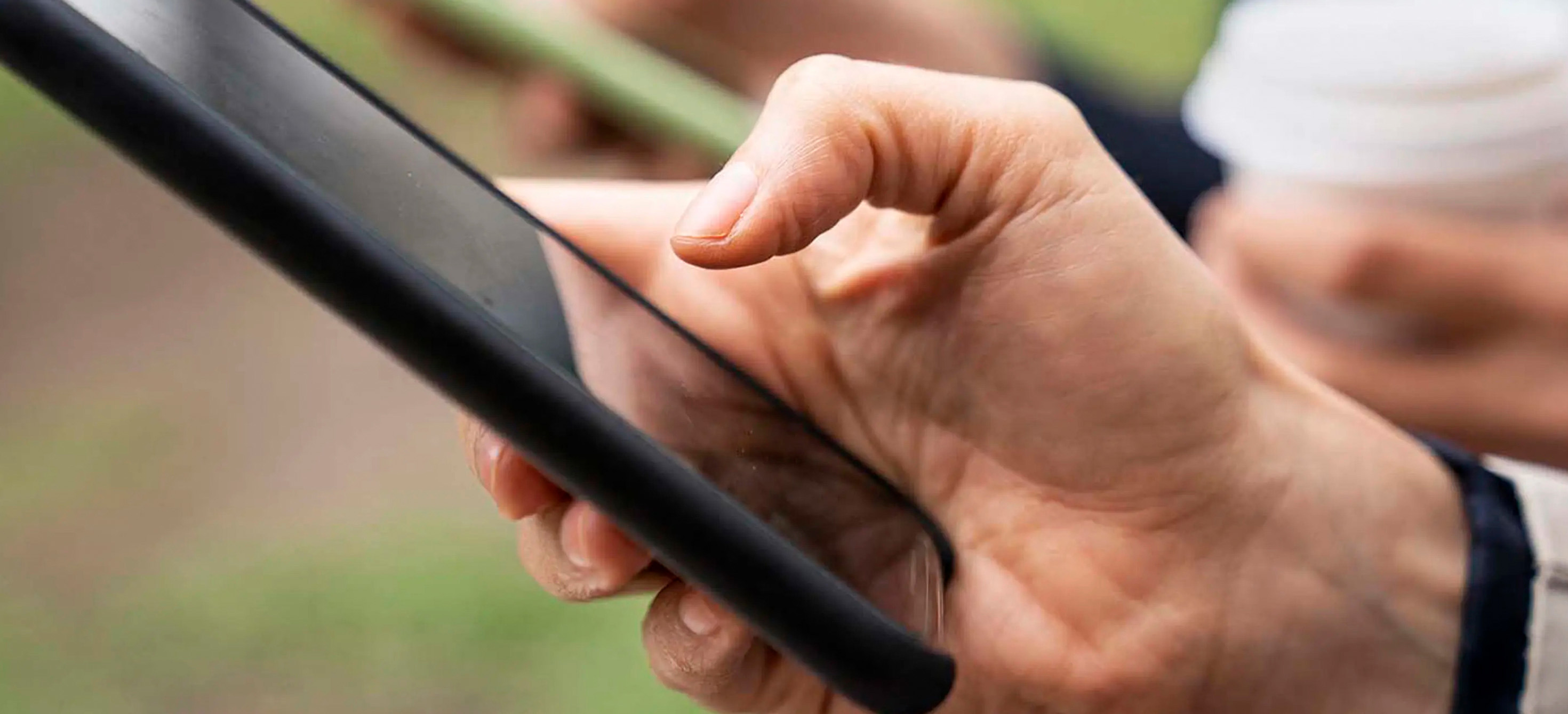 Close-up photo of hands holding smartphones