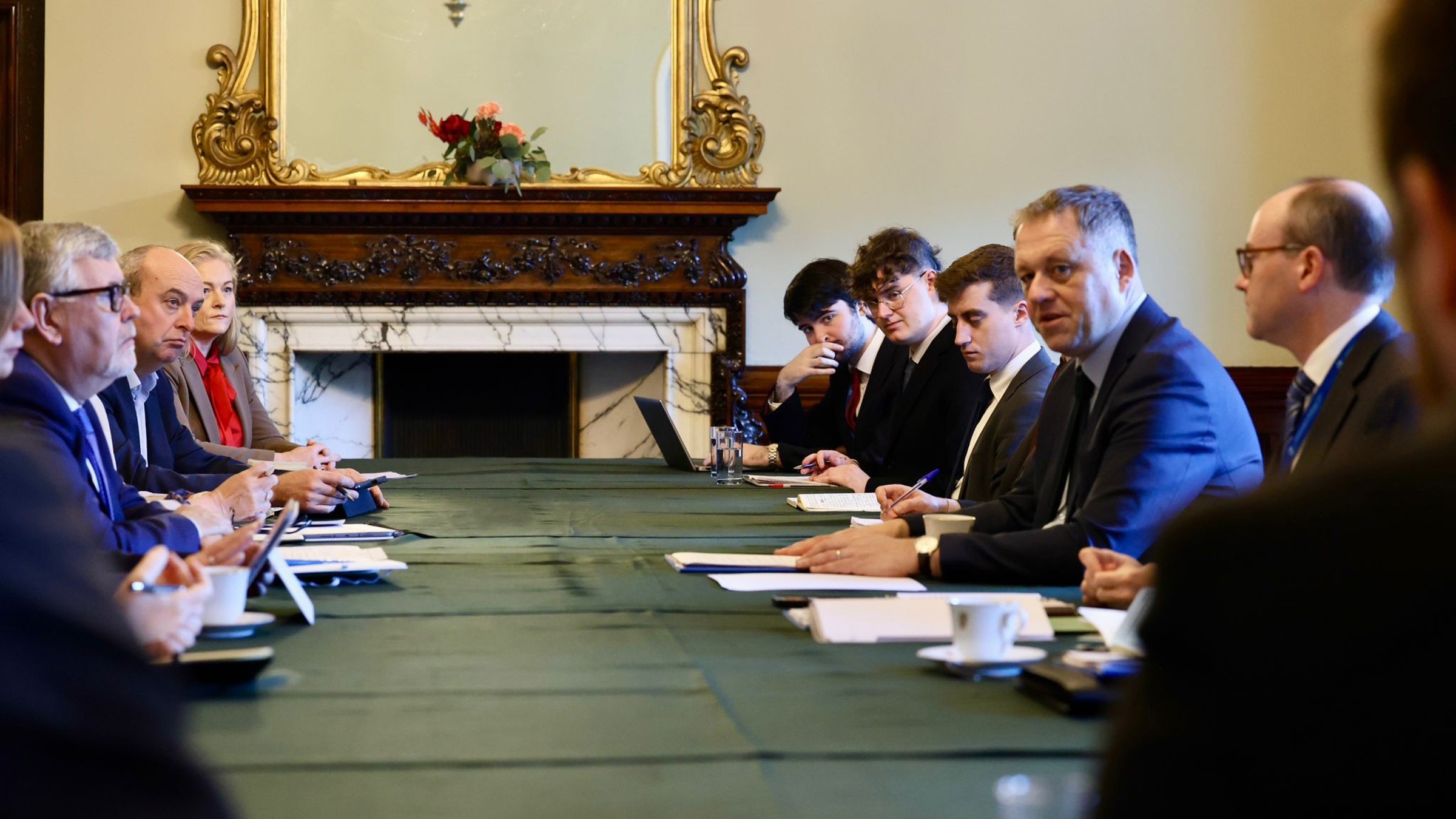 Minister Byrne at boardroom table with officials