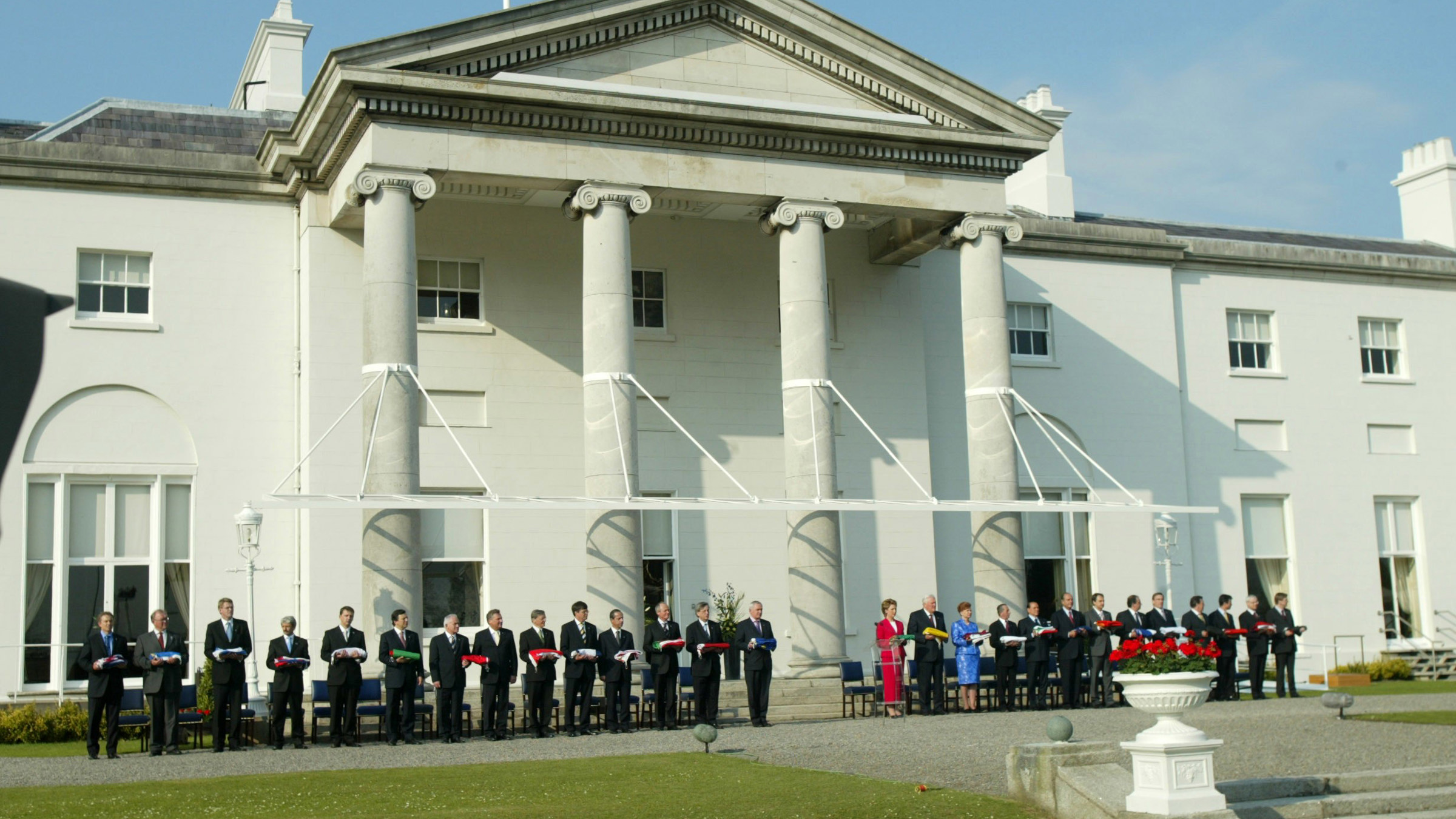 Photo of Irish and European political leaders standing in front of the Irish Presidential residence, Áras an Uachtaráin.